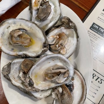 Wintzell's Oyster House signature dishes Wild-caught Raw Oysters on the Half ShellBienvilleCrab Claw Basket